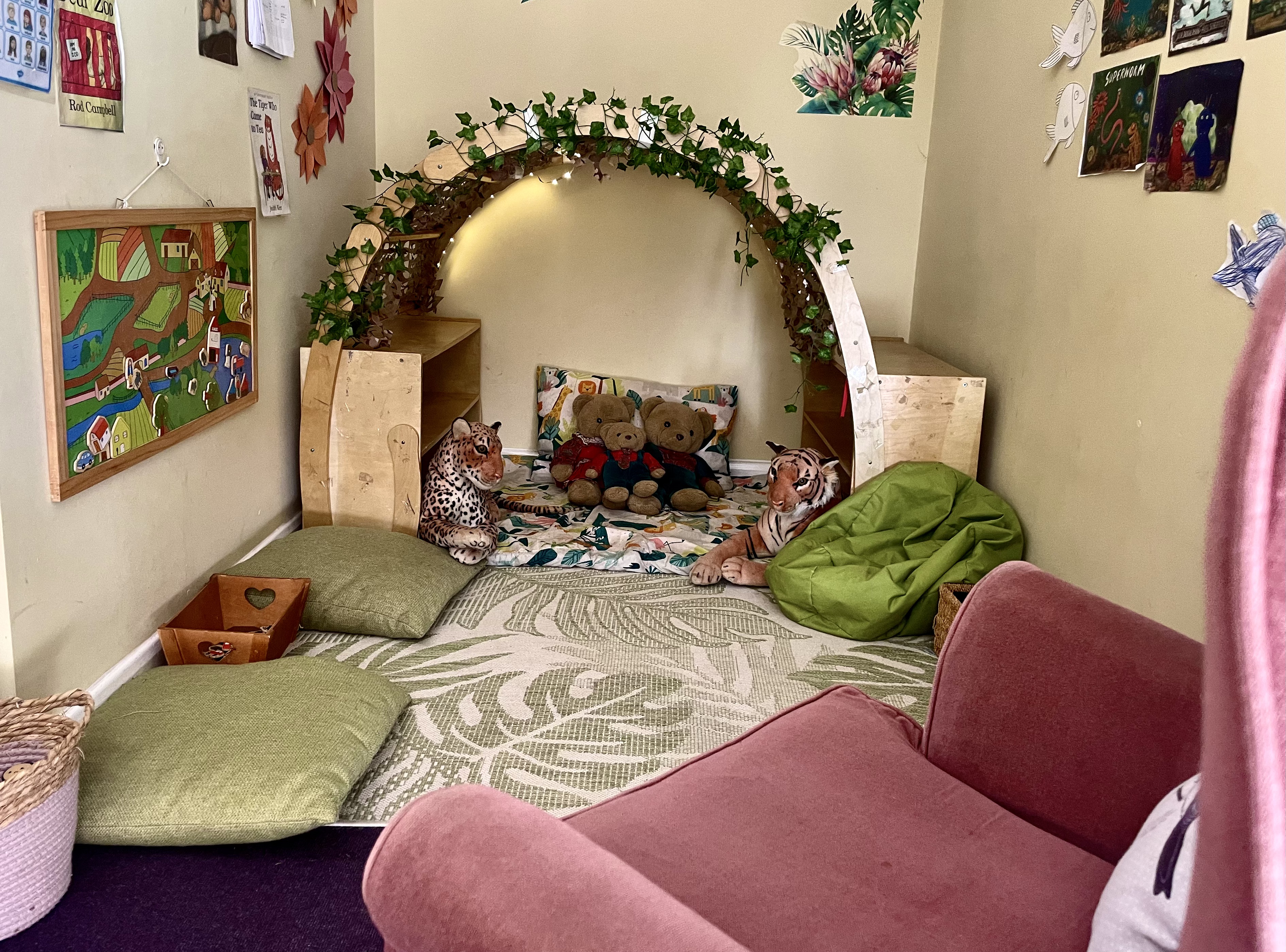 Photo of preschool reading corner with chair and many cushions. 