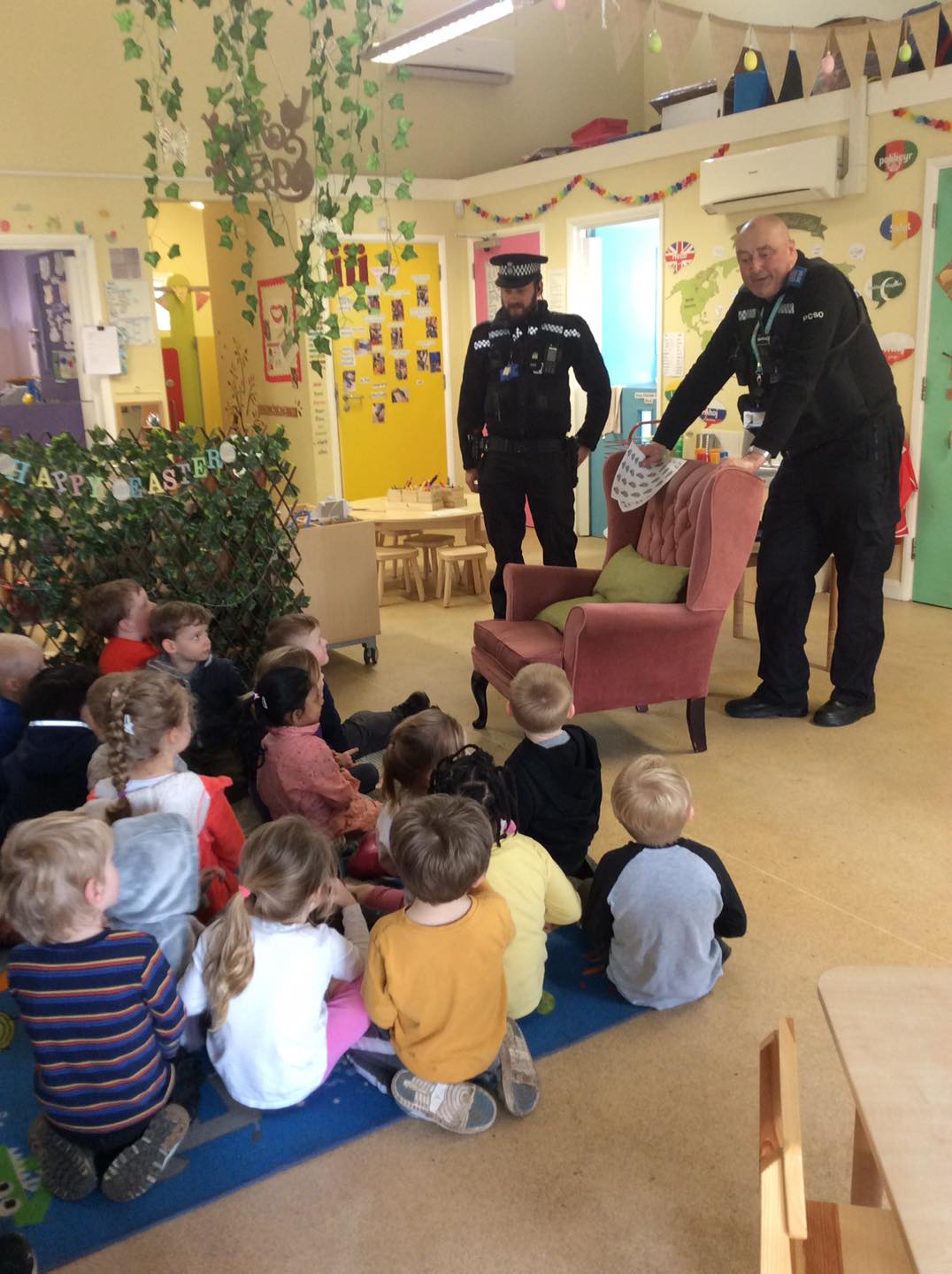 Two policemen presenting to a group of children